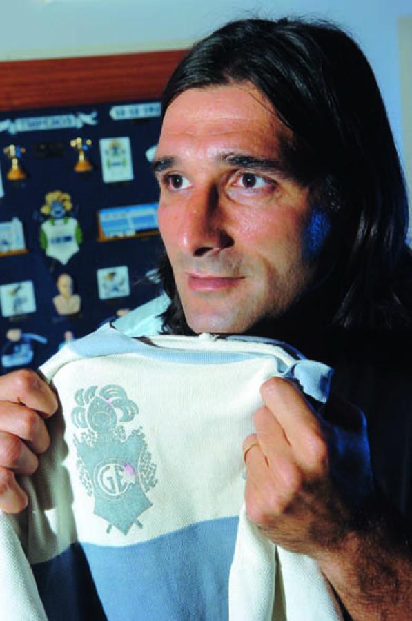 Imagen CON LA CAMISETA de Víctor Hugo "Copito" Andrada, del ascenso logrado por Gimnasia en 1984. De fondo, el regalo de un tripero. El museo del Gato en su casa.