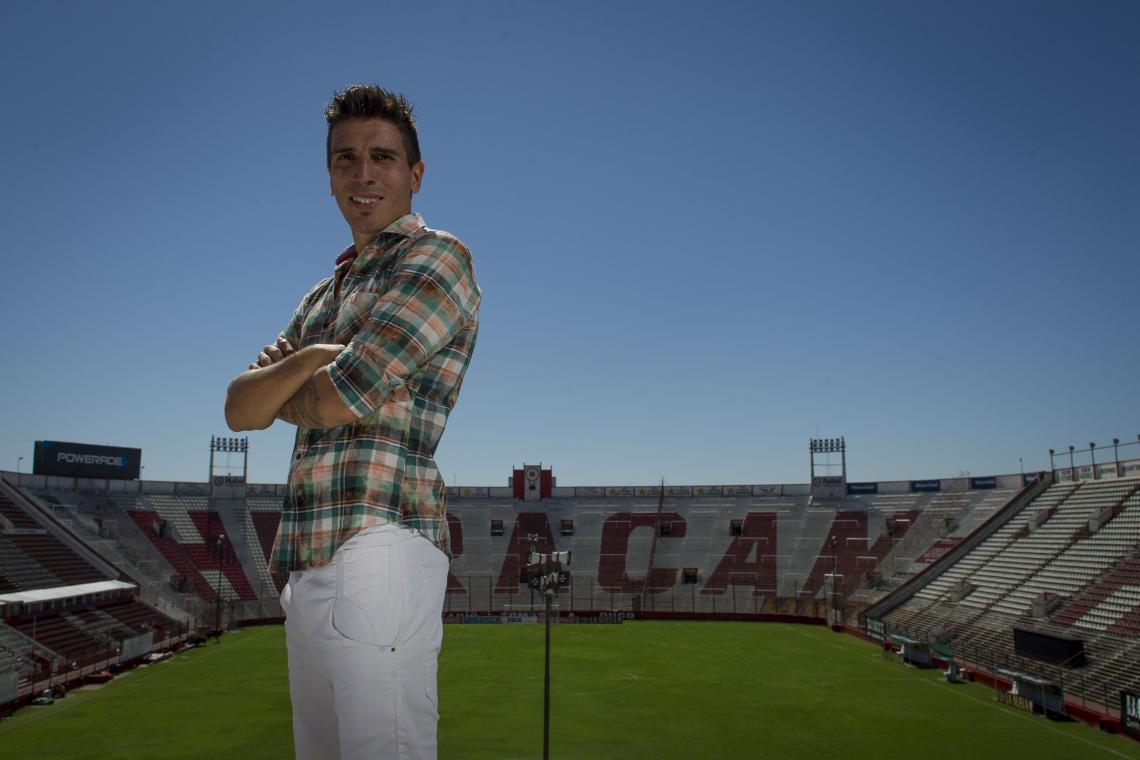 A un mes de cumplir 35 años posa en la popular de Huracán y lleva puesta una de las camisas que fabrica. En breve, lanzará su marca.