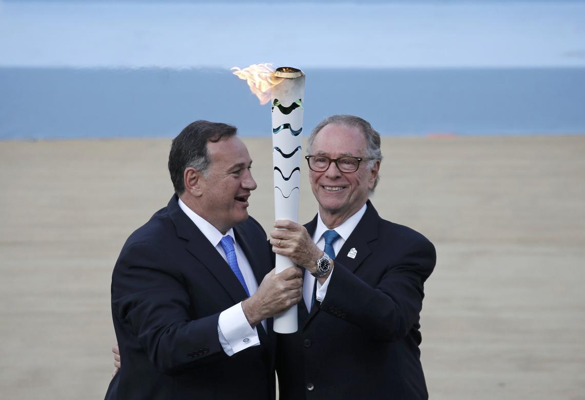 Imagen Spyros Capralos, jefe del Comité Olímpico Helénico (izq.) entrega la antorcha olímpica al jefe organizador de Río 2016, Carlos Nuzman, durante una ceremonia en el Estadio Panathinaikó, en Atenas, Grecia. (Reuters)