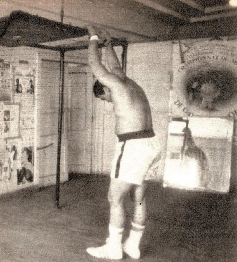 Imagen El esfuerzo de un hombre que está entrenando frente a los carteles que resumen la histroia del boxeo. Muhammad Alí es considerado como uno de los mejores boxeadores de la historia.